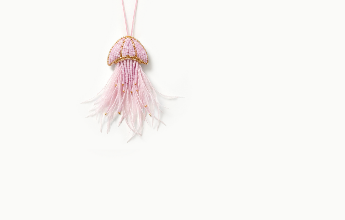 Pink beaded jellyfish bag charm with a feather fringe