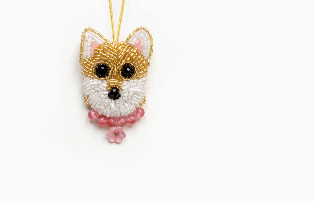 Gold and white beaded puppy face bag charm