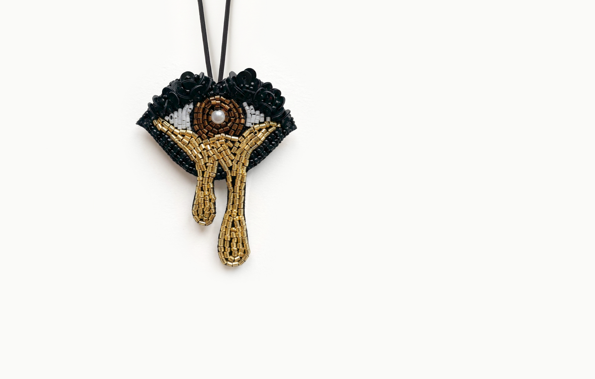 Gold and black beaded eye bag charm