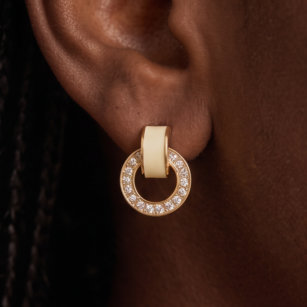 Link crystal earrings worn on the ear, cream band linked to a gold circle set with crystals