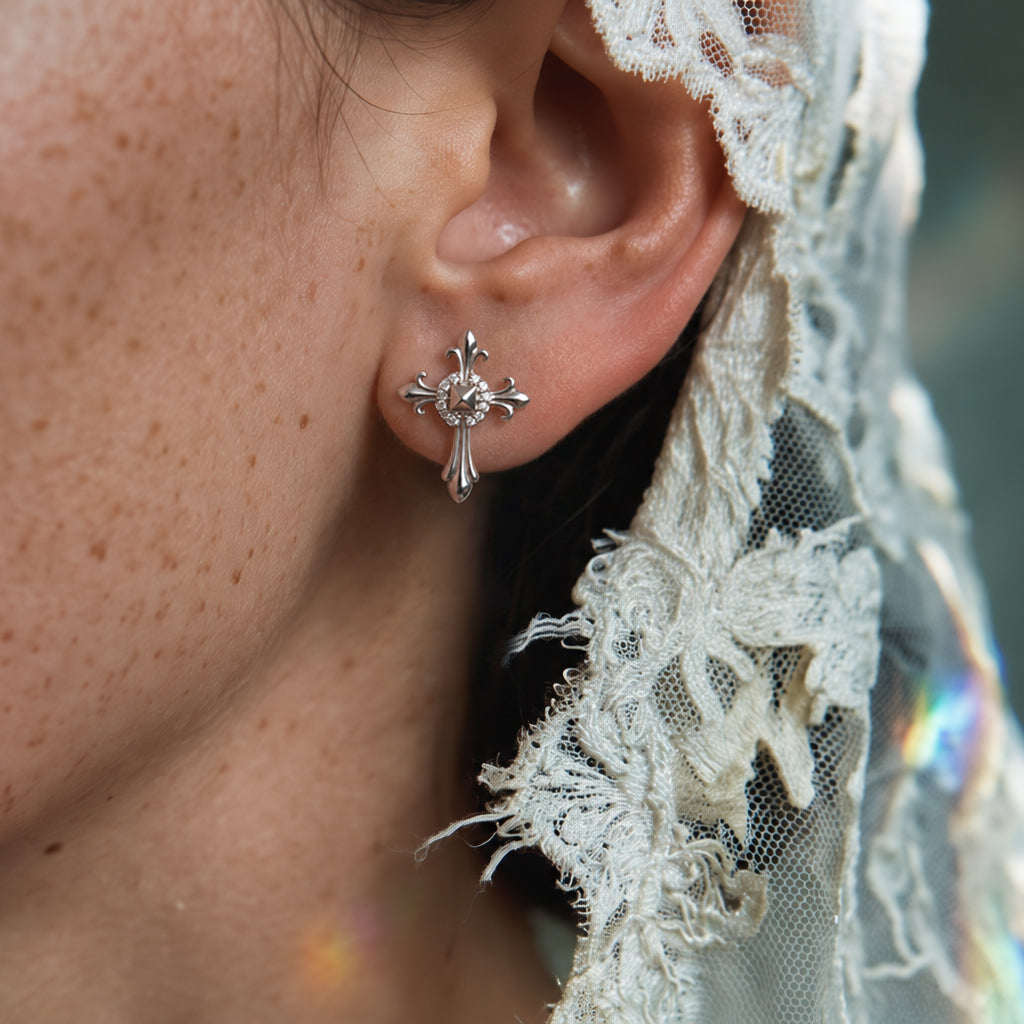 Melrose Cross crystal earring worn on the ear with a cream lace veil, small silver cross with a crystal center