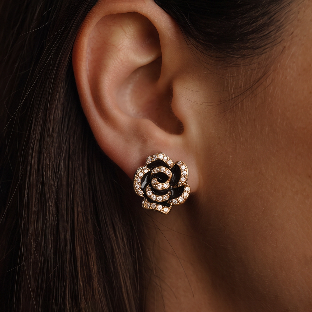 Black Rose crystal stud earring worn on the ear, rose with black petals edged in crystals, long brown hair behind