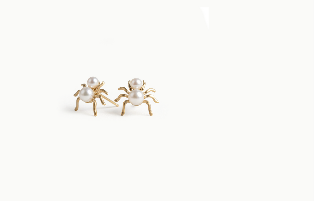 Gold spider stud earrings with two pearls for a body