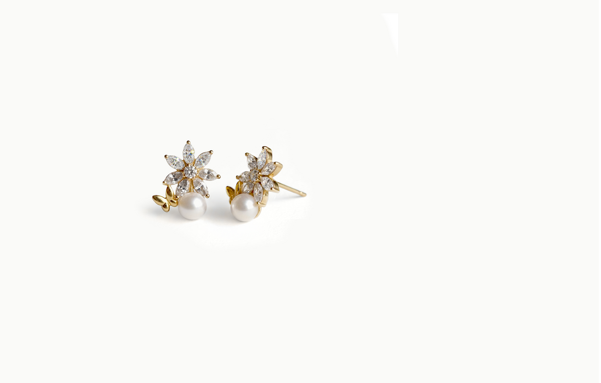 Gold crystal flower stud earrings with a pearl and a small butterfly