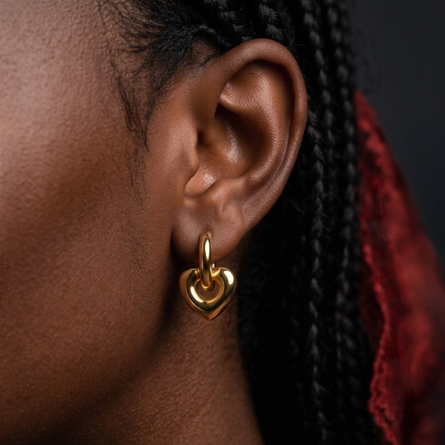 Chunky Heart Hoop earring worn on the ear, small gold hoop with a gold heart drop, braided hair behind