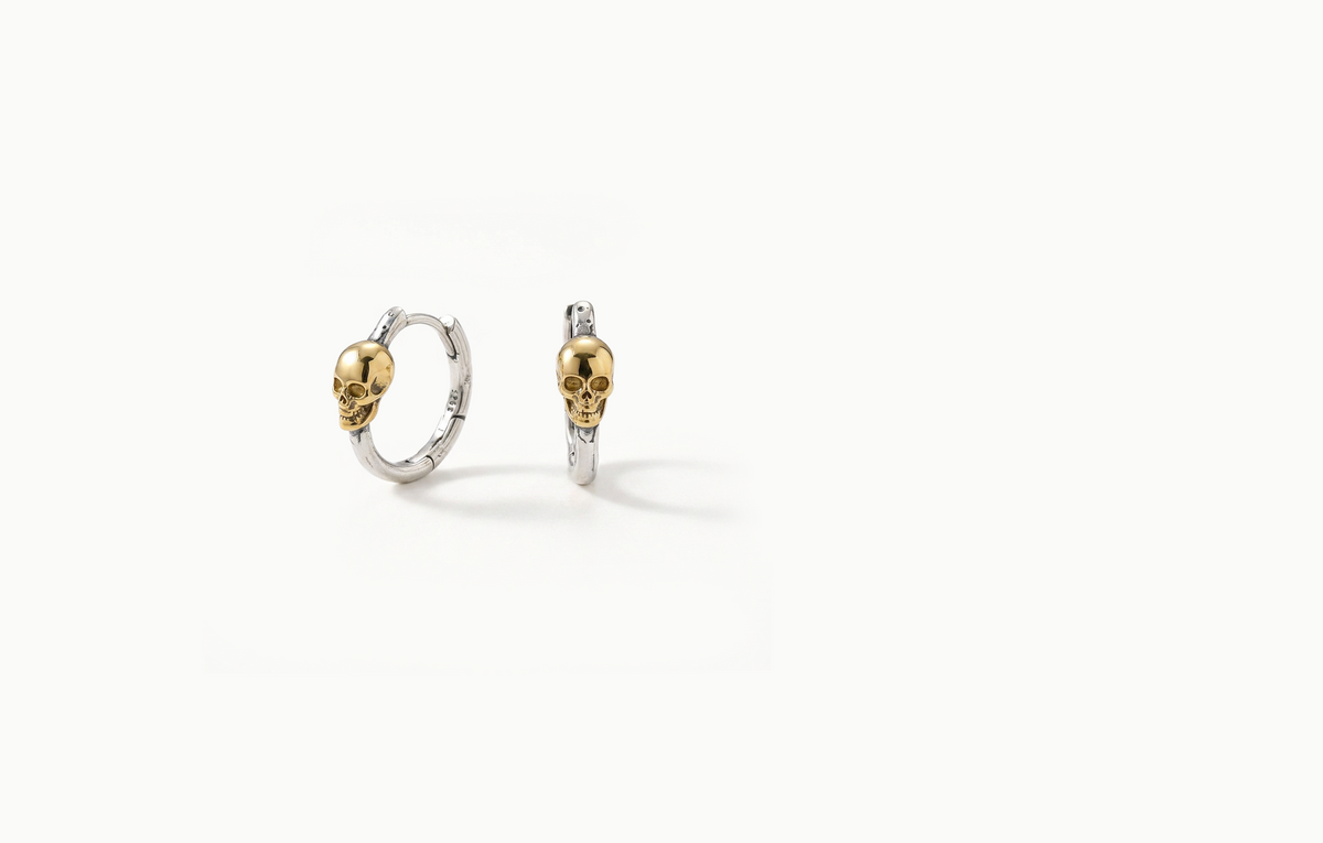Silver hoop earrings with a gold skull
