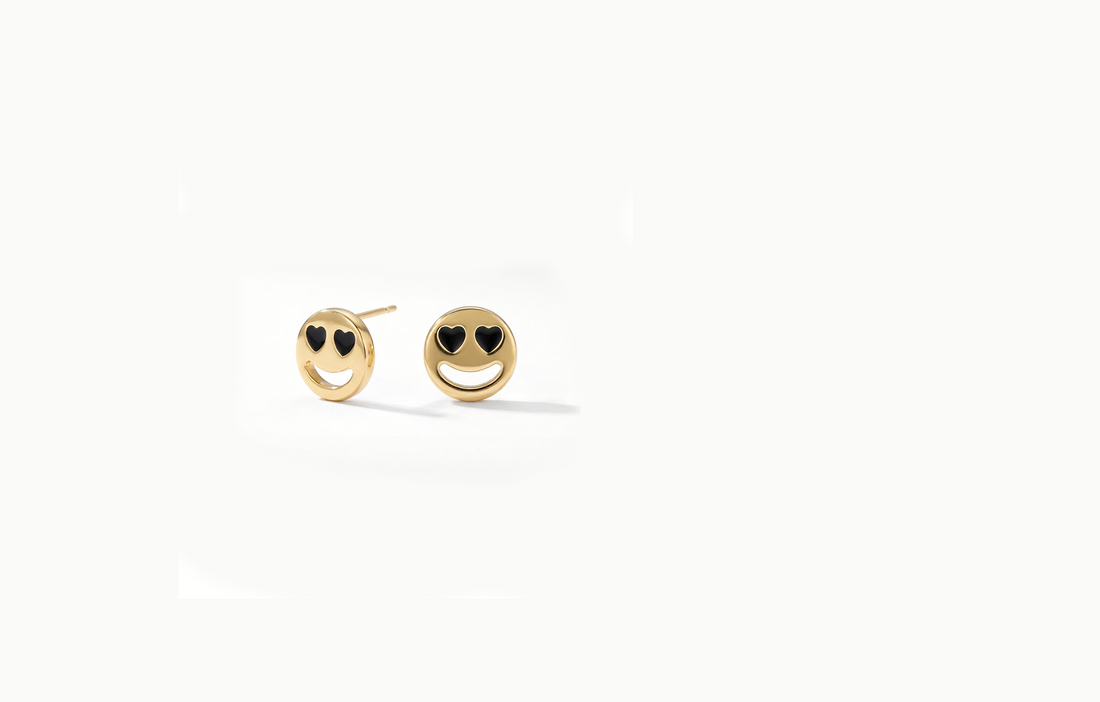 Gold smiley face stud earrings with black heart eyes