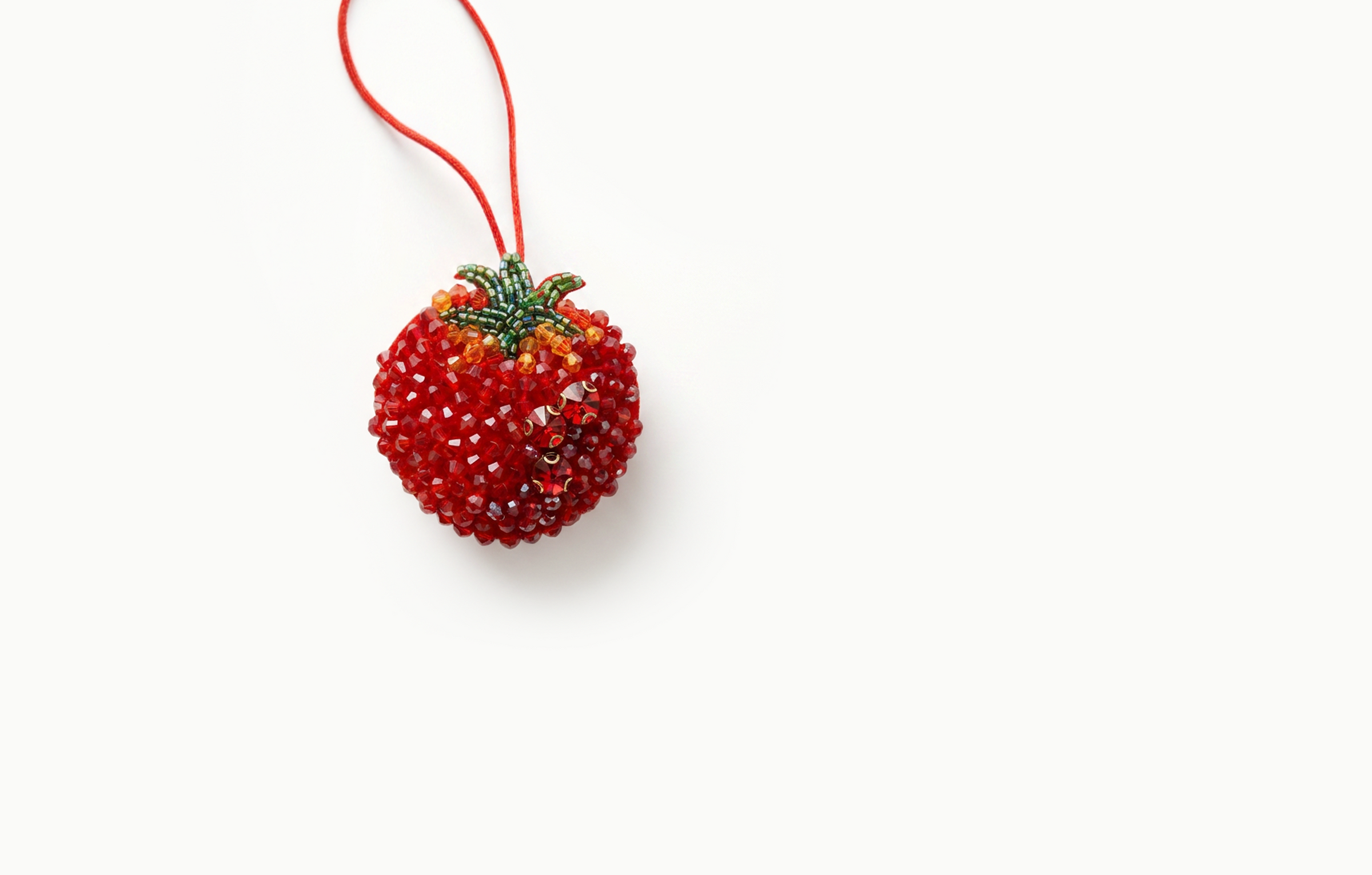 Red beaded tomato bag charm with a green beaded stem