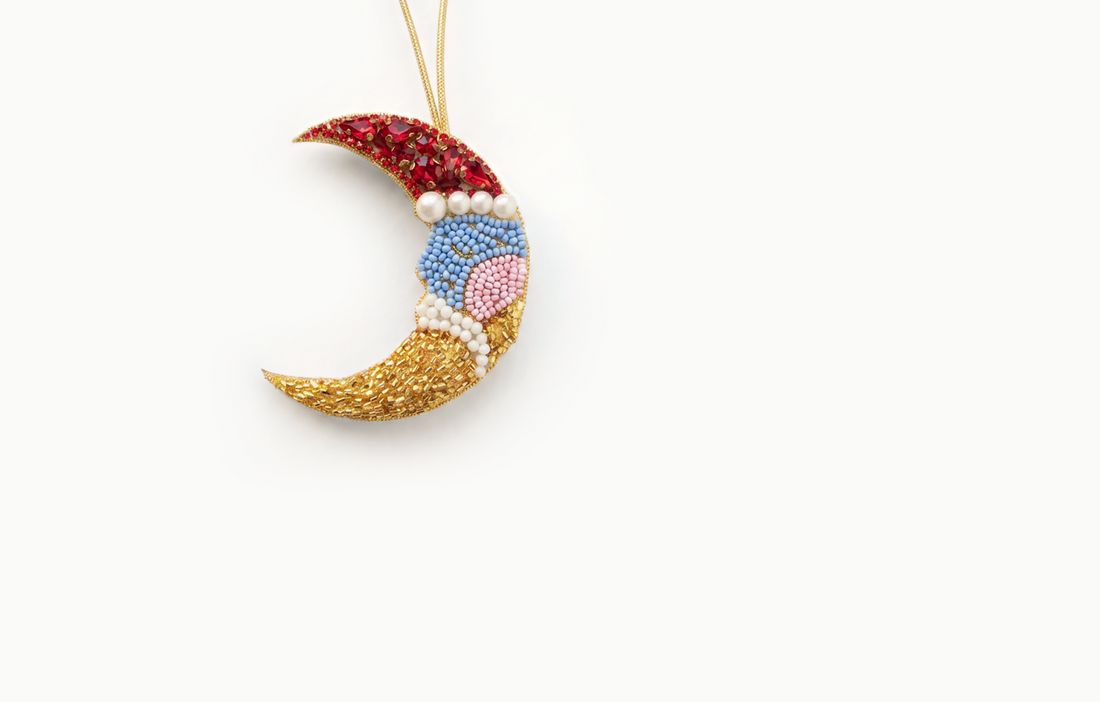 Gold beaded crescent moon bag charm with red and pastel beads