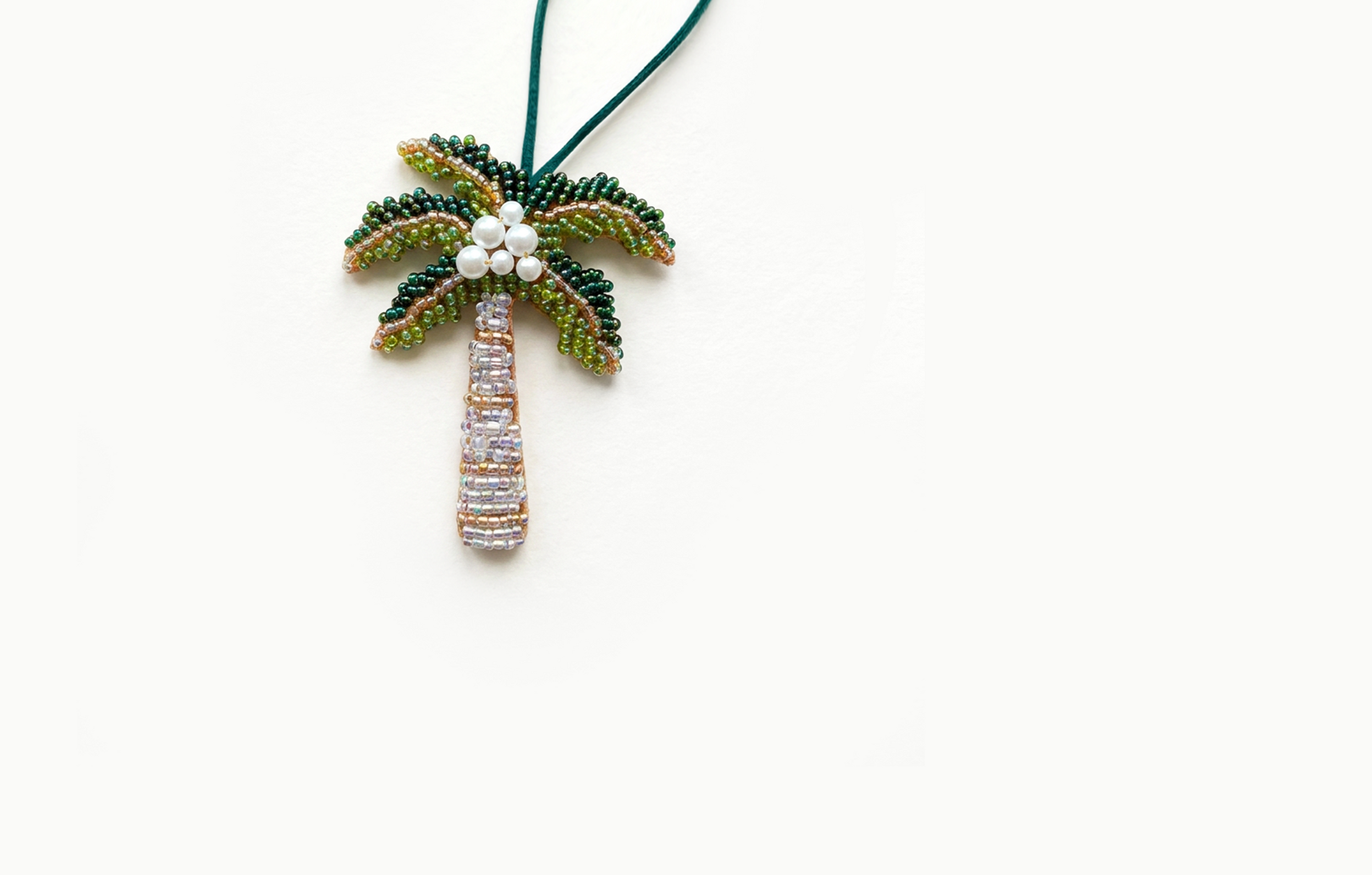 Green beaded palm tree bag charm with a pale trunk