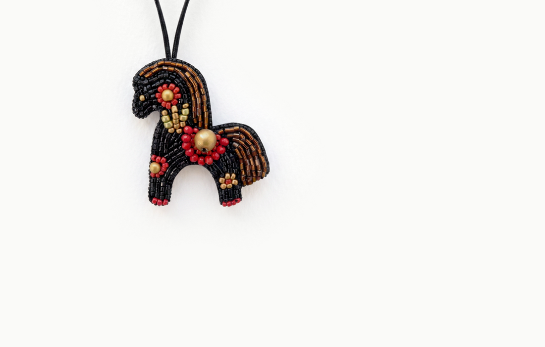 Black and brown beaded horse bag charm with red and gold flowers