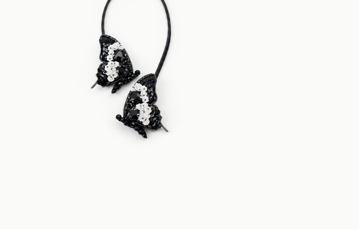 Two black beaded and sequined butterfly bag charms