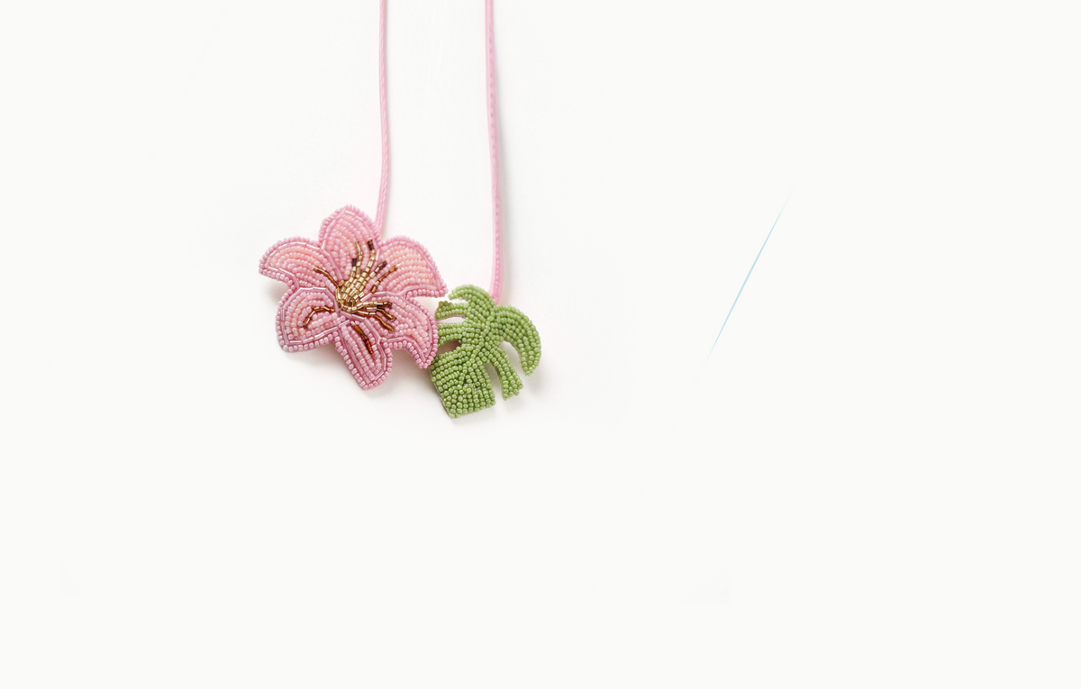Pink beaded hibiscus and green leaf bag charm