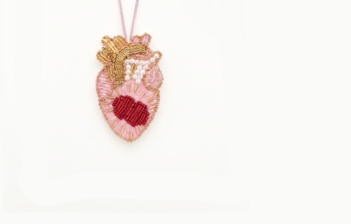 Pink beaded heart bag charm with a red centre