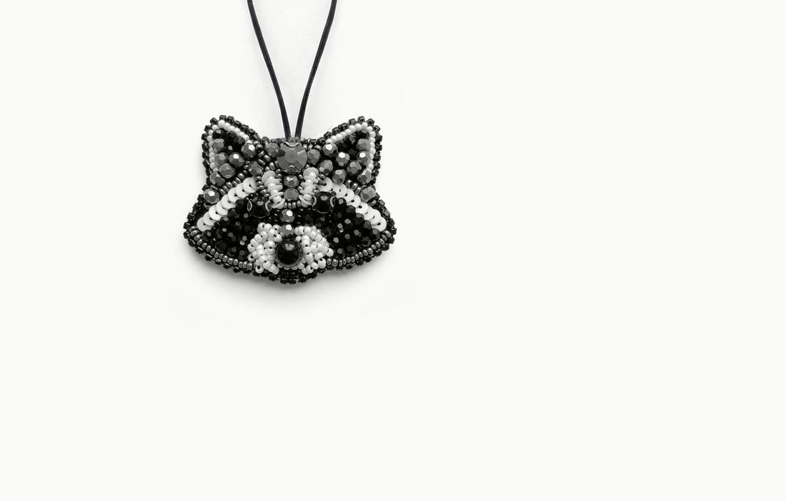Black and white beaded raccoon bag charm