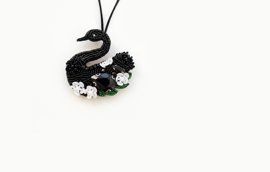 Black beaded swan bag charm with white flowers