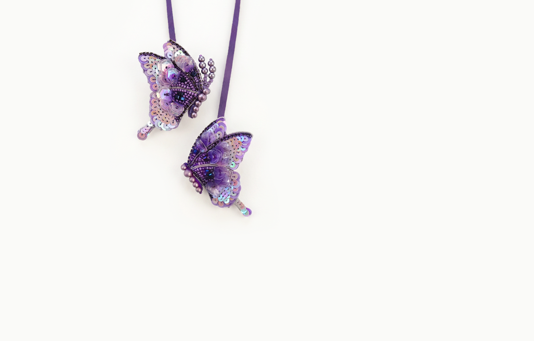 Two purple beaded and sequined butterfly bag charms