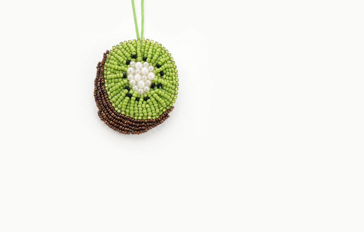 Green beaded kiwi slice bag charm