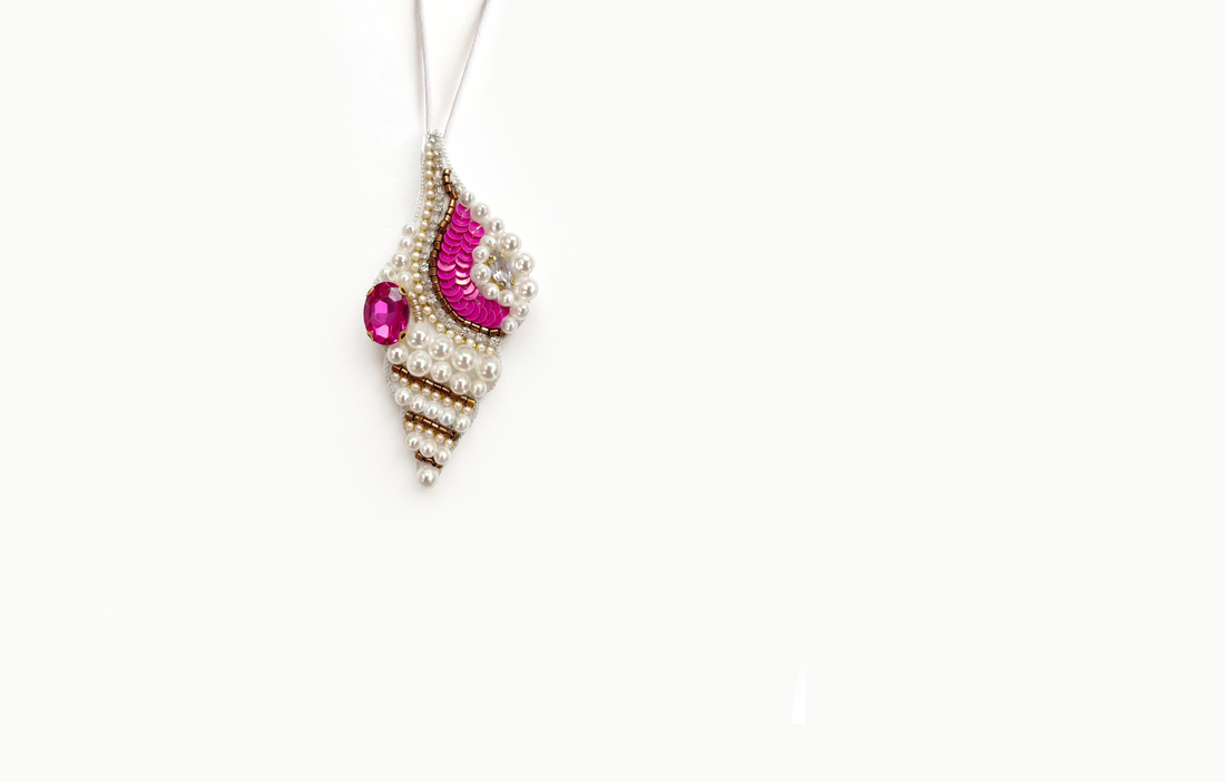 Ivory beaded conch shell bag charm with pink sequins