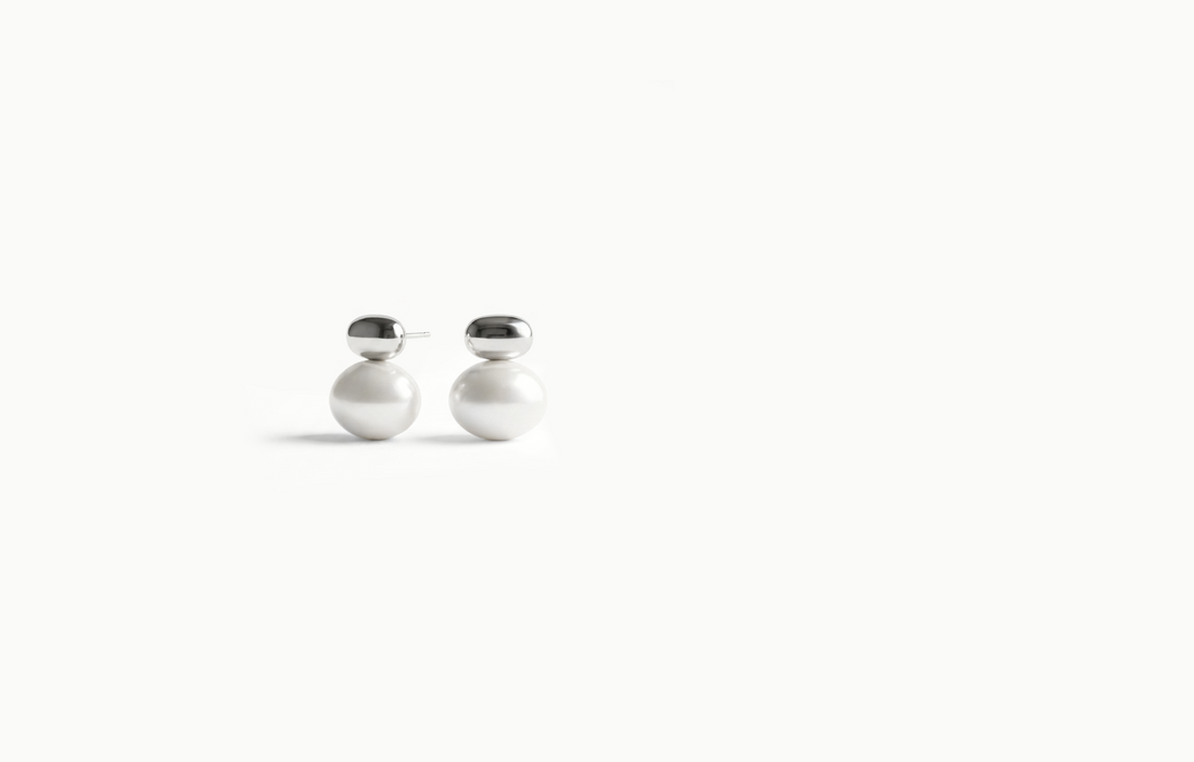 Large pearl stud earrings with a smooth silver cap