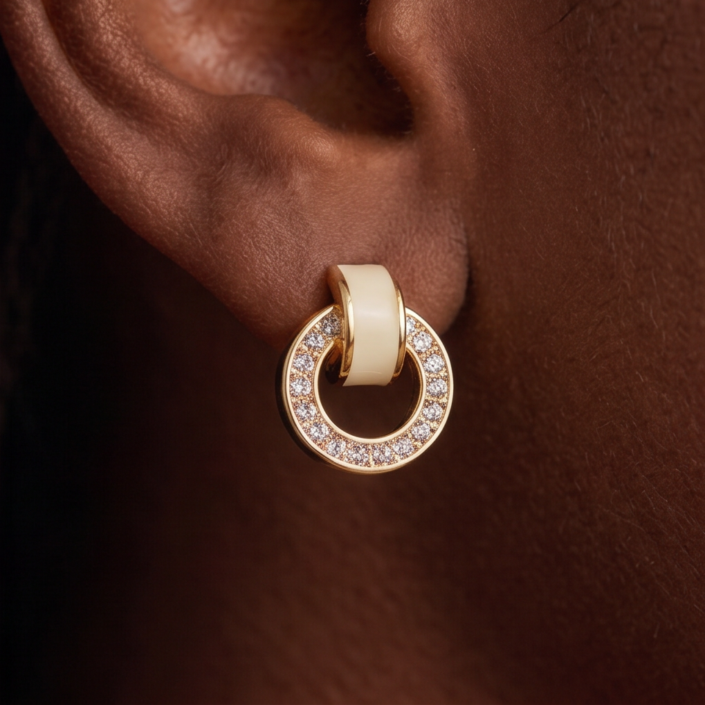 Link crystal earrings, close-up of a cream band and gold circle of crystals on the ear