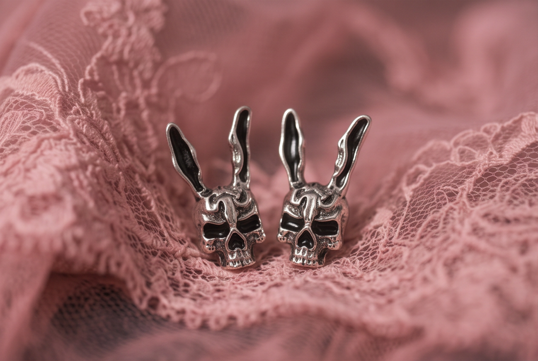 Darko Rabbit Skull stud earrings pair on pink lace, silver rabbit skulls with long ears and black eye sockets