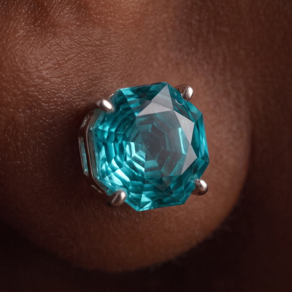 Algarve Crystal stud earrings, macro of a round teal crystal in a prong setting on the ear