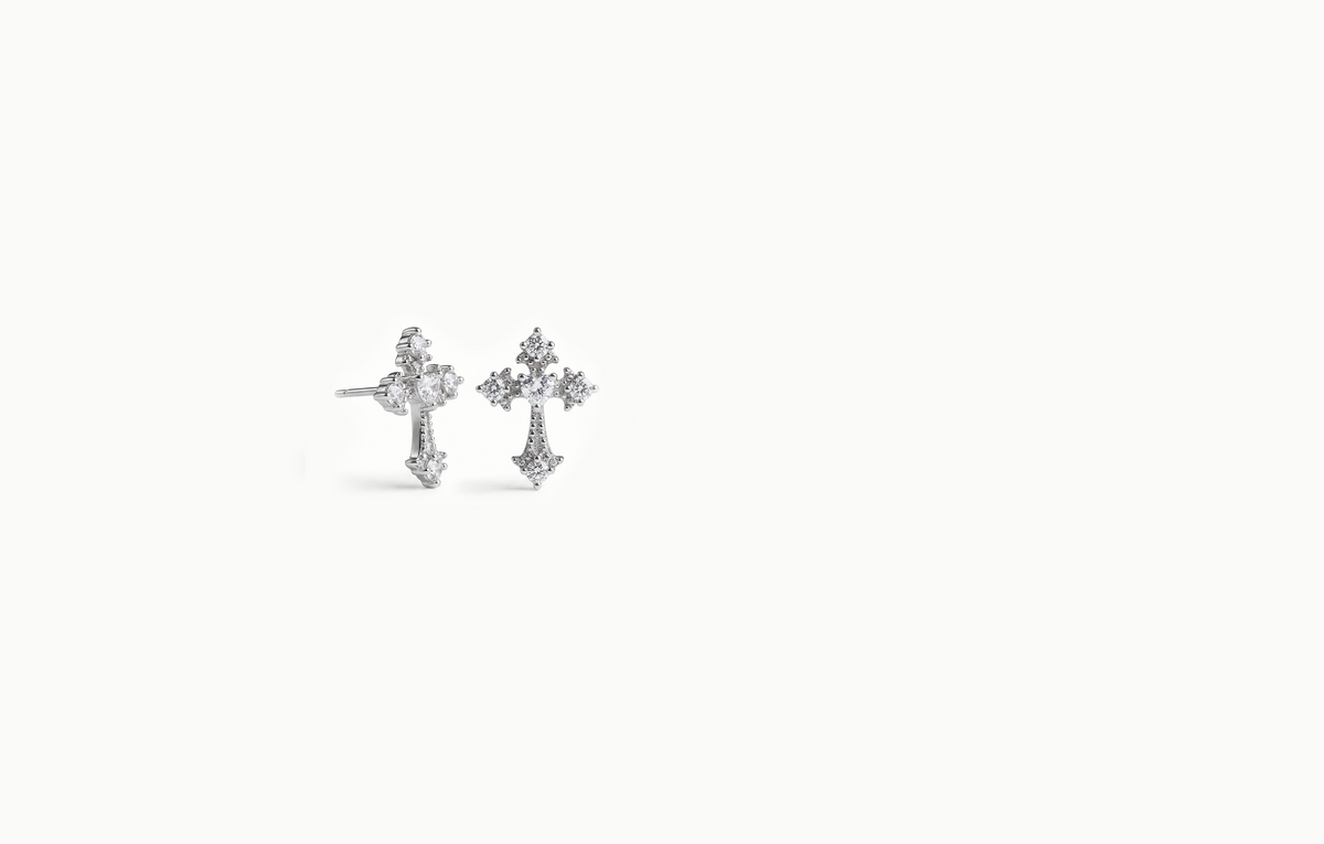 Silver cross stud earrings covered in crystals
