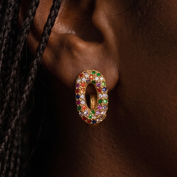 Kaleidoscope Crystal hoop earrings worn on the ear, oval gold hoop with multicolor crystals, braided hair