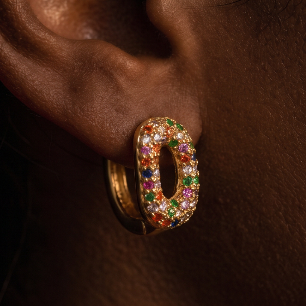 Kaleidoscope Crystal hoop earrings, close-up of an oval hoop covered in multicolor crystals on the ear