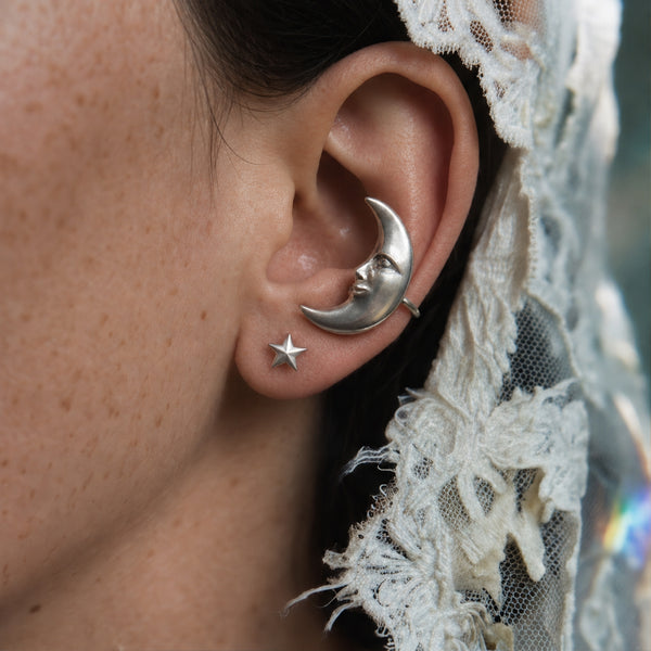 Goodnight Moon ear cuff on the other ear, silver crescent moon face with a star stud and a lace veil behind