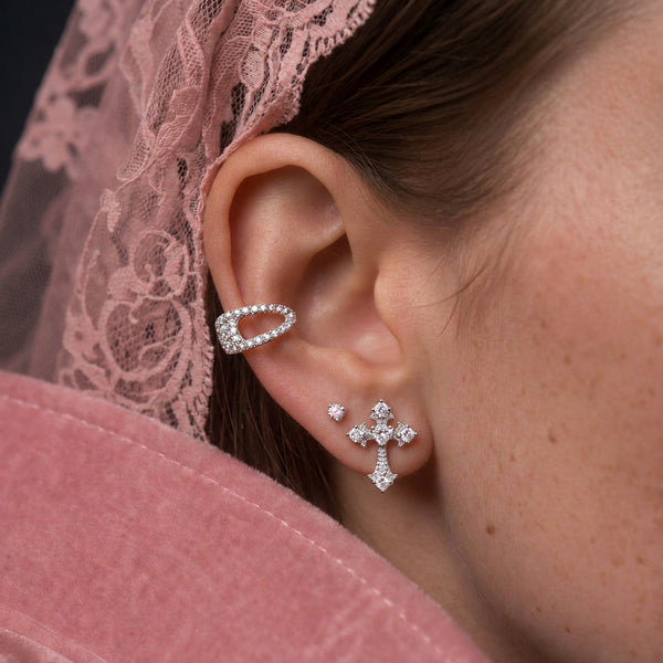 Crystal Cross stud earrings; a silver crystal cross worn on the ear with a crystal ear cuff, pink lace veil behind