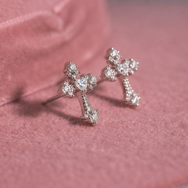 Crystal Cross stud earrings; a pair of silver crystal crosses resting on a pink felt hat