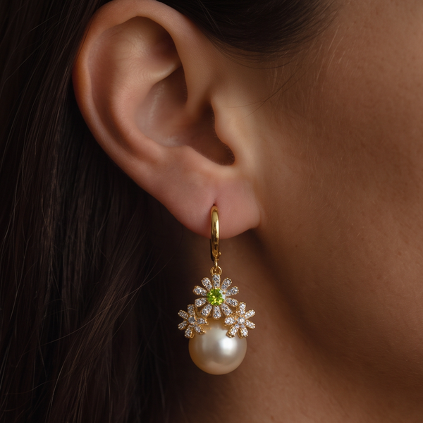 Garden Party crystal pearl earrings worn on the ear, gold hoop with crystal daisies and a cream pearl drop