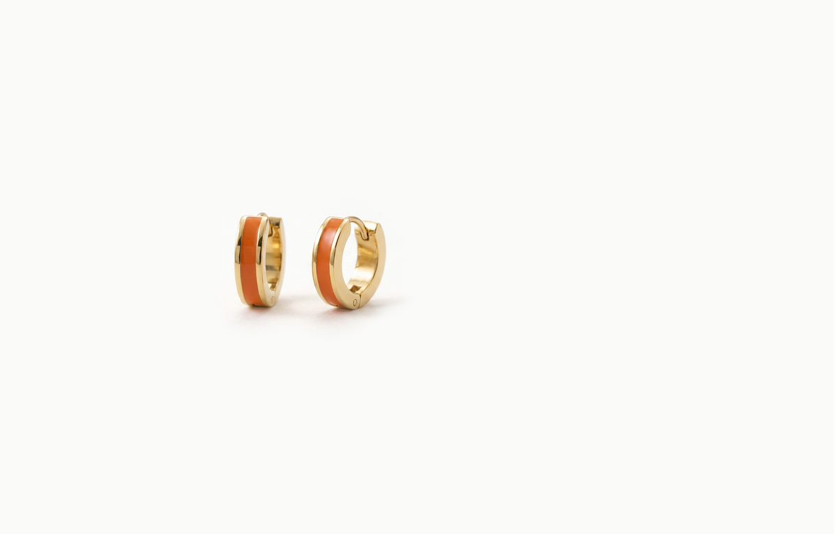 Chunky gold hoop earrings with an orange inlay