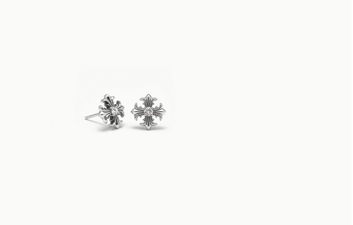 Ornate silver cross stud earrings with a crystal