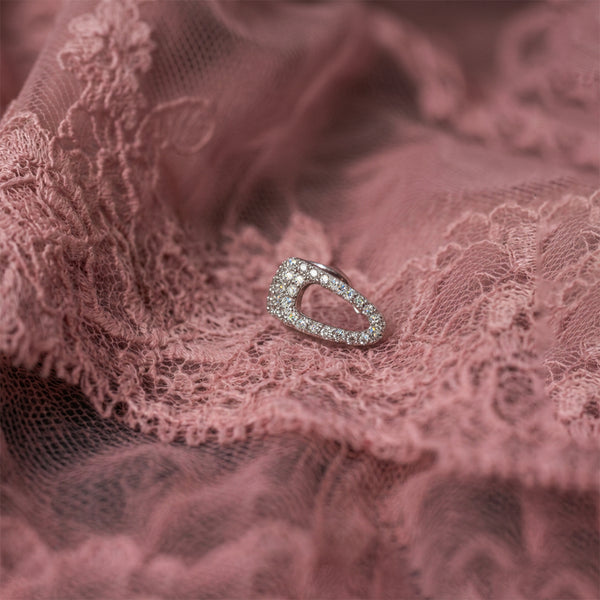 Crystal Hair-Clip ear cuff laid flat on dusty pink lace, an open crystal-covered silver shape
