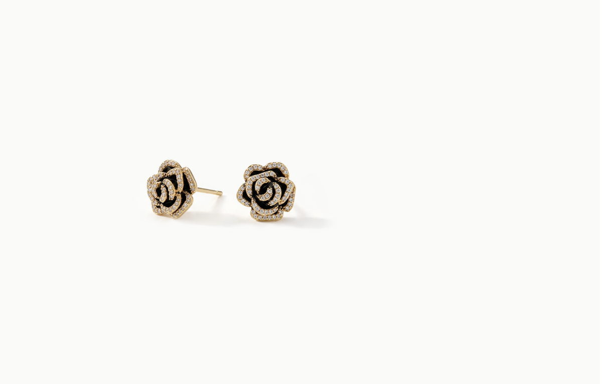 Black rose stud earrings with petals outlined in gold crystals