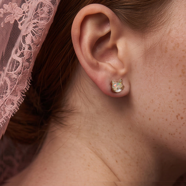 Mini Kitten stud earring worn on the ear, gold cat face with whiskers and crystal ears, pink lace behind