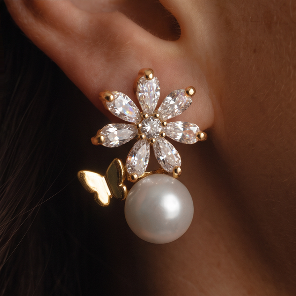 Crystal Flower Pearl earrings worn on the ear against dark hair, crystal petals and pearl drop
