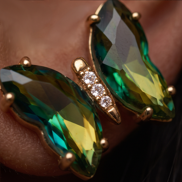 Absinthe Crystal Butterfly earrings extreme close-up, green and yellow crystal wings with a small crystal-set body