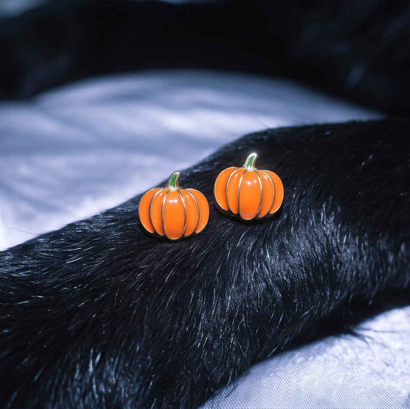 Pumpkin Patch stud earrings pair resting on black fur with grey satin fabric behind