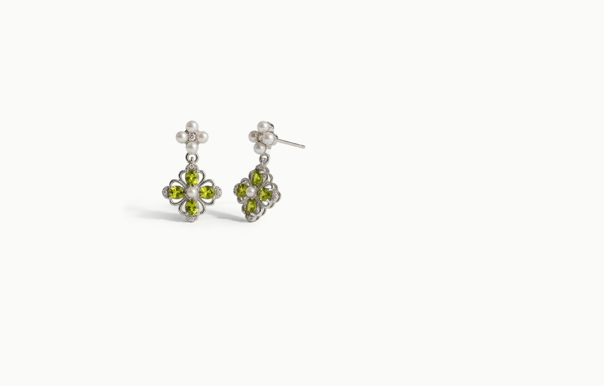 Silver drop earrings with a cluster of small pearls and a green crystal flower