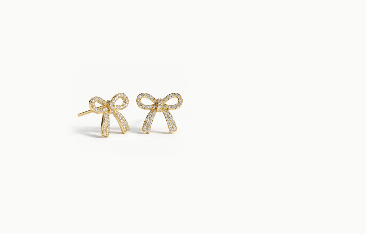 Gold bow stud earrings covered in crystals