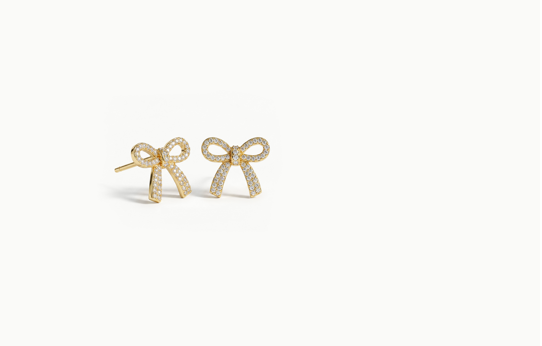 Gold bow stud earrings covered in crystals