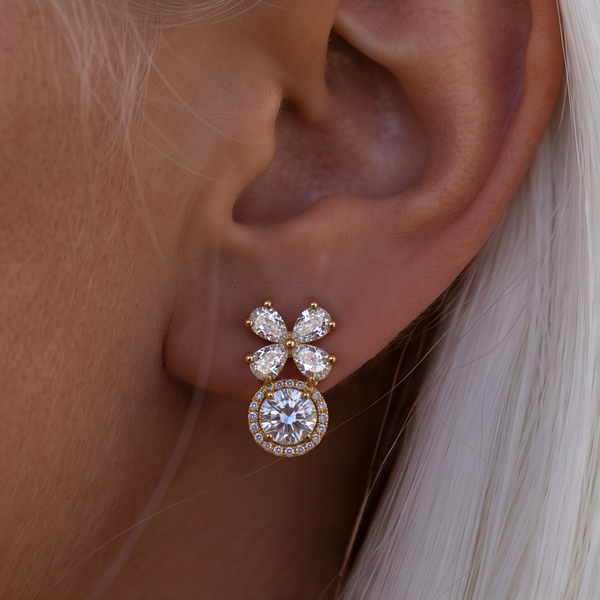 Crystal Blossom Halo earring worn on the ear, close-up of crystal petals over a round halo, white hair behind
