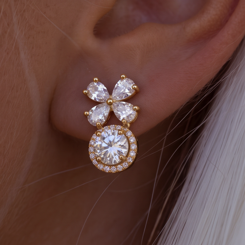 Crystal Blossom Halo earring extreme close-up on the ear, four crystal petals above a round crystal with a halo