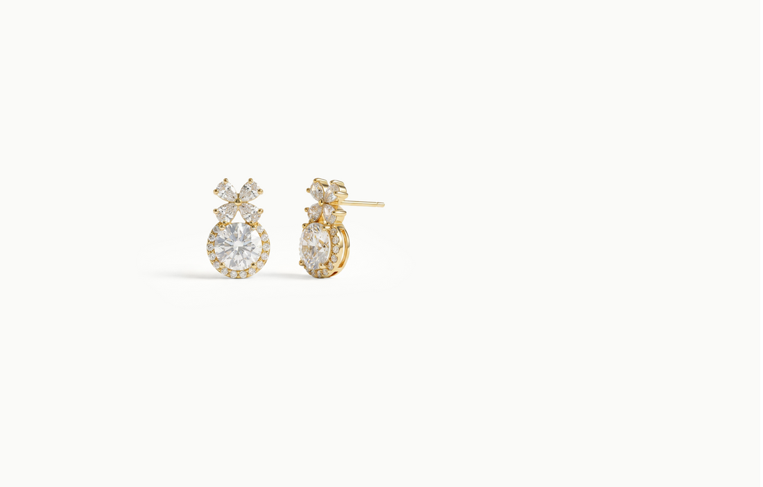 Gold stud earrings with a crystal flower above a large halo crystal