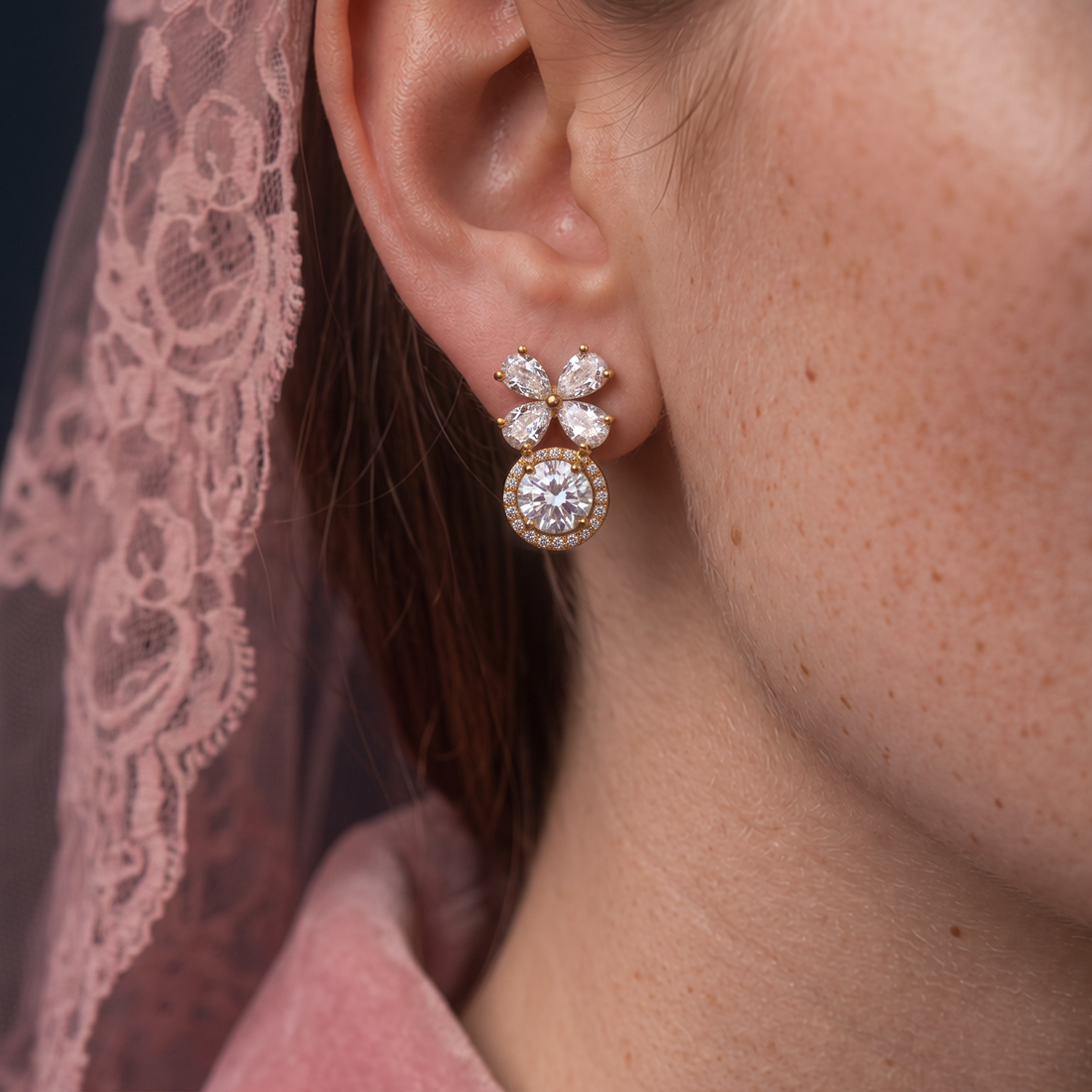 Crystal Blossom Halo earring worn on the ear, crystal flower above a round crystal halo, pink lace and pink velvet
