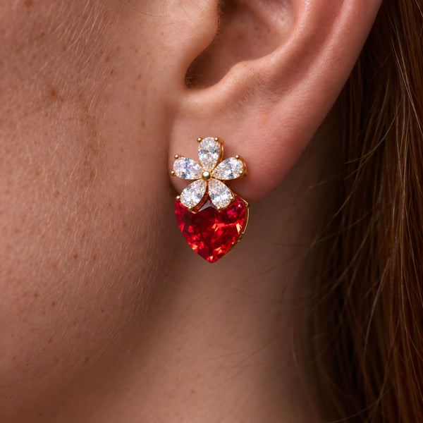 Strawberry Fields crystal earring worn on the ear, crystal flower and red crystal strawberry, auburn hair behind